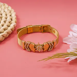 Close-up of gold mesh bracelet featuring 'Best Friend' heart and star compass charms
