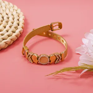 Close-up of a gold mesh bracelet with crystal heart charms and best friend engraving