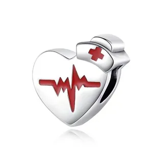 Detailed close-up of a silver heart-shaped nurse charm with a red heartbeat line.