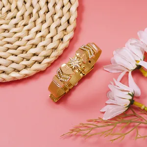 Detailed view of gold mesh bracelet featuring rhinestone star and heart charms for women