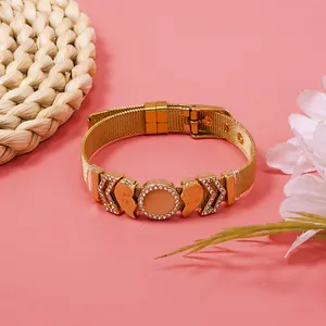 Detailed view of gold mesh bracelet with rhinestone heart Best Friend charms