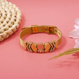 Detail view of gold mesh bracelet with heart and lollipop charms for best friends