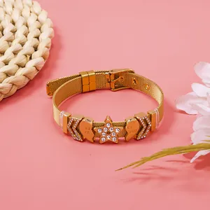 Detailed view of a gold mesh bracelet with rhinestone star and split heart charms