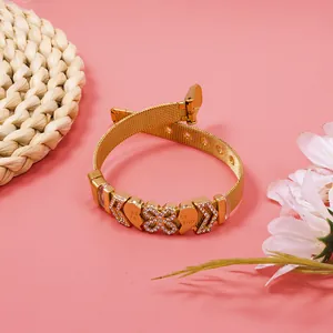 Detail of gold mesh bracelet with sparkling rhinestone charms and BEST FRIEND engraving