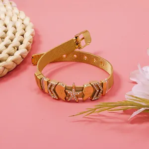 Detailed close-up of a gold mesh adjustable bracelet with rhinestone heart and star charms