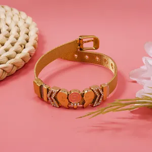 Detailed view of gold mesh bracelet with rhinestone heart and 'Best Friend' charms