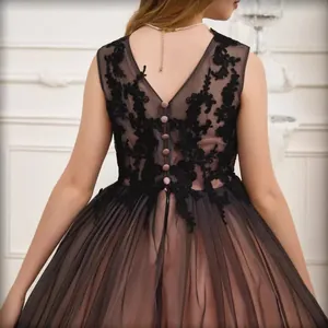 Back detail of an elegant lace flower girl dress with V-neck and black tulle layers