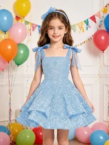 Detail of blue sequined flower girl dress with elegant bow shoulder straps for party