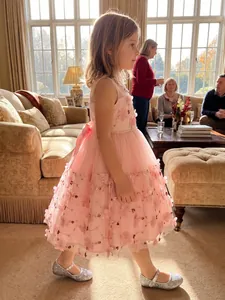 Detailed view of an elegant pink flower girl dress featuring 3D floral embroidery and lace.