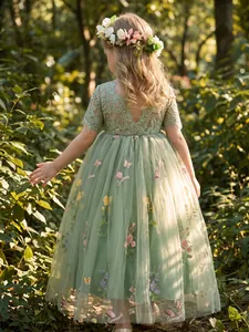 Back view of girl's sage green tulle dress with floral embroidery and lace sleeves
