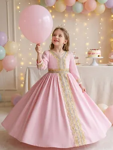 Close-up of elegant pink girl's dress with intricate gold lace and pearl detailing.