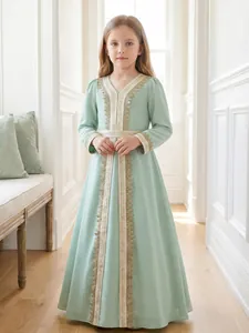 Detail of girls ethnic sage green long dress with gold lace embroidery and sleeves.