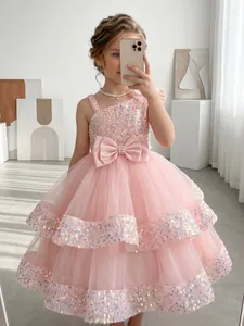 Pink sequin flower girl dress with tulle skirt and waist bow detail