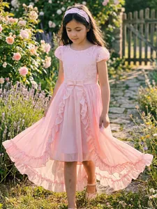 Close-up detail of a pink high-low flower girl dress with lace bodice and chiffon skirt