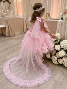 Detailed view of the elegant pink ruffled tulle princess dress with a long train