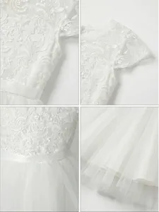 Detailaufnahmen von elegantem weißen Spitzenoberteil und Lagen aus Tüllnetz