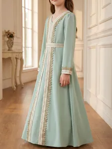 Detailed view of elegant gold lace trimming on a mint green girl's ethnic long gown
