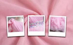 Details of pink mesh dress featuring one-shoulder bow and sequin waist belt.