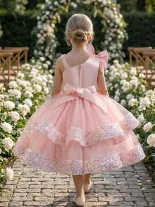 Detailed back view of elegant pink sequined tulle flower girl dress with a large satin bow