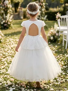 Detailed back view of white lace bodice and hollowed-out back on flower girl dress