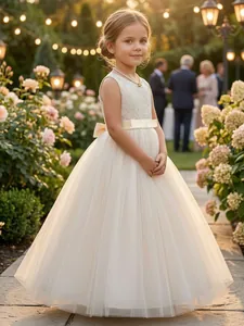 Elegant ivory lace flower girl dress with a voluminous tulle skirt and satin bow