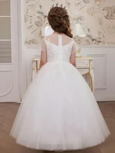 Back view of elegant white flower girl dress with delicate lace embroidery and tulle