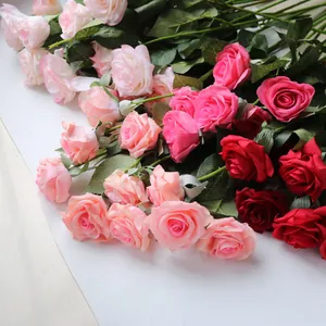 Close-up view of artificial moisturizing silk roses in vibrant pink and red hues
