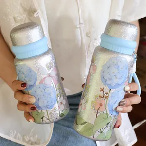 Detail view of 3D floral printed titanium-coated insulated stainless steel water bottles.