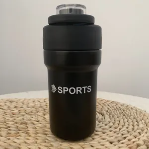 Close-up of a black 304 stainless steel insulated sports water bottle on a straw mat