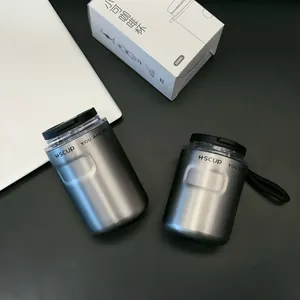 Close-up detail of metallic grey insulated coffee cups with lids and original box