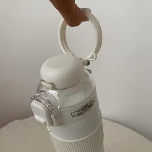 Close-up of the white insulated water bottle lid with a durable portable ring handle