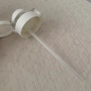 Detail view of white thermos cup lid with long drinking straw attachment