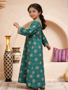 Side view of elegant teal girl's dress with gold lace details in a stylish interior