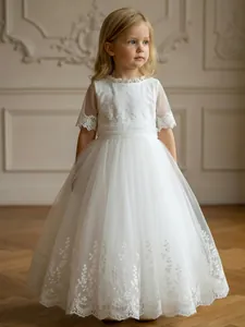 Detailed view of the white lace and embroidered tulle on this elegant flower girl dress