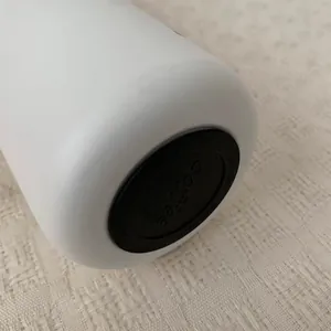Detailed close-up of the non-slip rubber base of a white insulated water bottle