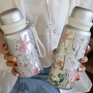 Close-up detail of exquisite 3D lily floral print on silver titanium insulated water bottles