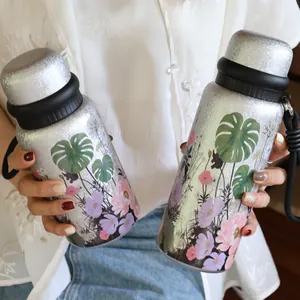 Detail of titanium coated vacuum flask with 3D floral pattern and carrying strap
