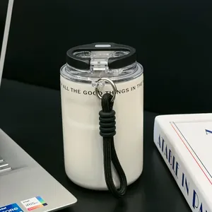 Detailed macro view of white insulated stainless steel coffee cup with carry strap