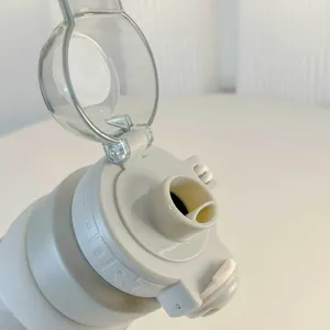 Close-up view of grey sport insulated water bottle lid with an open clear cover