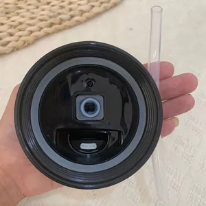 Detailed macro view showing the leak-proof black lid and clear straw of a water bottle