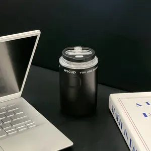 Modern black 304 stainless steel insulated coffee mug with dual lid on a minimalist desk