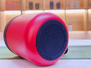 Close-up of red stainless steel coffee mug base with hand wash only instruction.