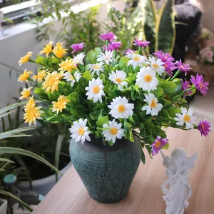 Colorful artificial 7-fork daisies and chamomile bouquet in a rustic green vase