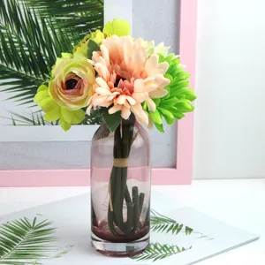 Close-up of artificial gerbera daisy and rose bouquet in a purple glass vase.