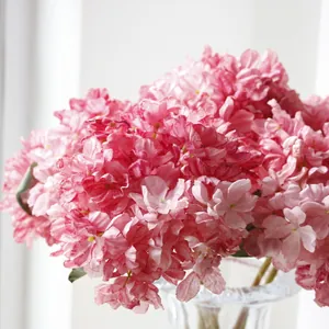 Macro close-up of vintage coral artificial hydrangea petals with delicate burnt edges