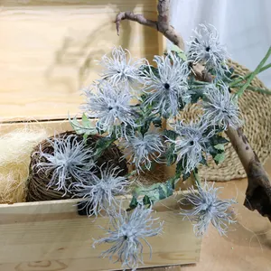 Detailed view of flocked grey sea urchin artificial flowers in a wooden rustic box