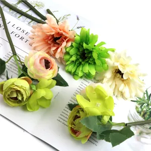 Detailed close-up of colorful silk gerbera and rose bouquet arranged on an open magazine