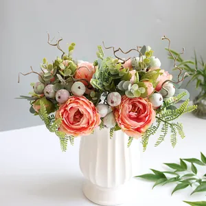 Detailed view of artificial pink peony flower arrangement in a ribbed white ceramic vase