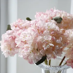 Detailed macro shot of pink French vintage scorched edge artificial hydrangea flowers.
