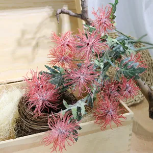 Close-up of pink flocked artificial crab claw chrysanthemum in a rustic wooden box